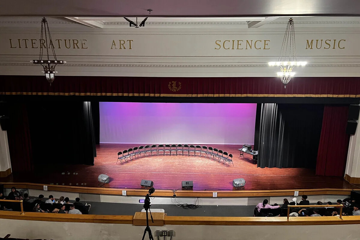 Audience reacting during a high school hypnosis show