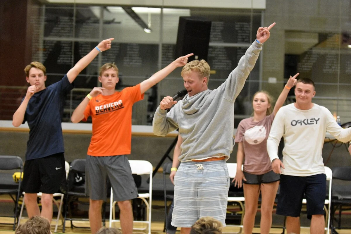 Students with fake microphones during a hypnosis show
